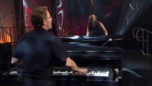 stand up comedian Michael and Amy playing piano on stage