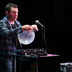Comedy Magician Eric Buss with a balloon