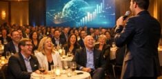 Corporate event audience laughing during live entertainment performance, illustrating the human connection AI cannot replace in event planning