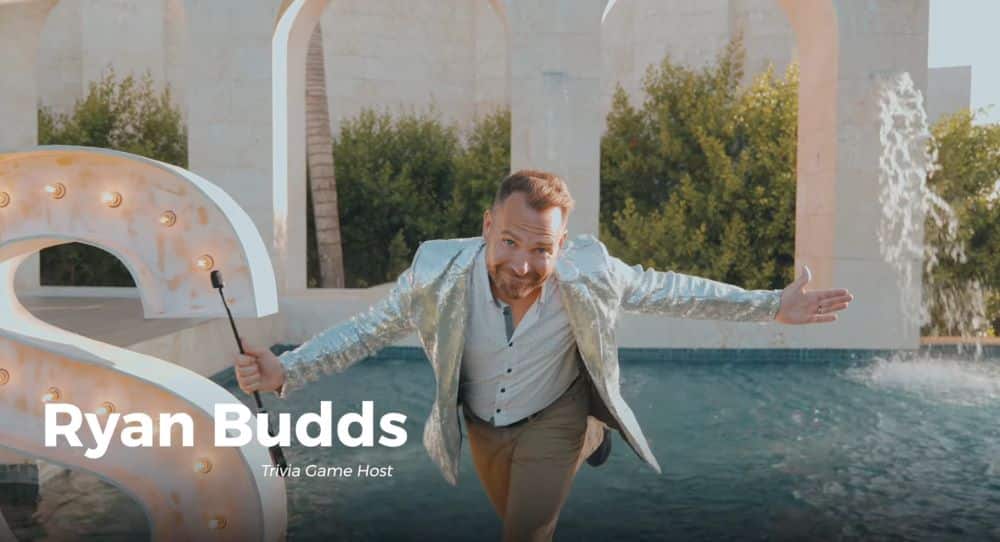 Ryan Budds, corporate retreat game show host, performing at a branded event